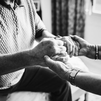 Senior couple holding hands together